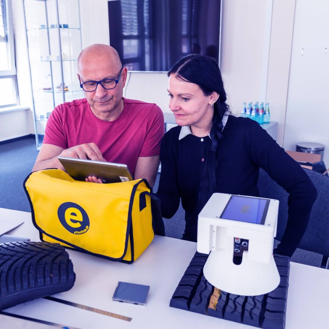 Zwei Personen betrachten etwas in einem Tablet.