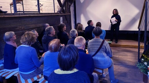 Person steht vor einer Leinwand und spricht zum Publikum.